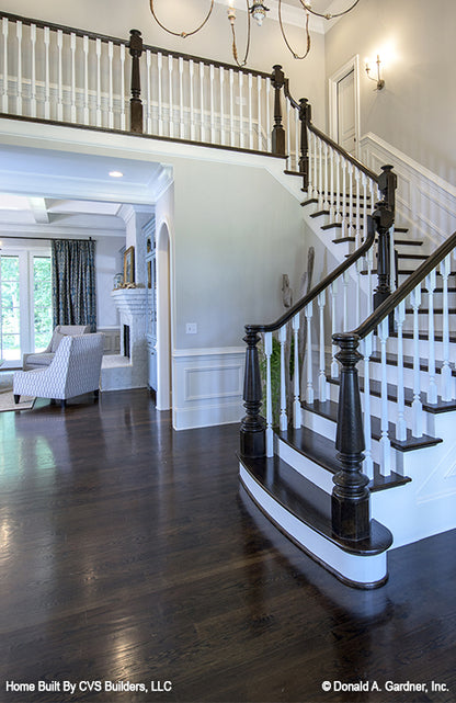 Dark espresso-stained wood and white staircase. The Carrera plan 1178.