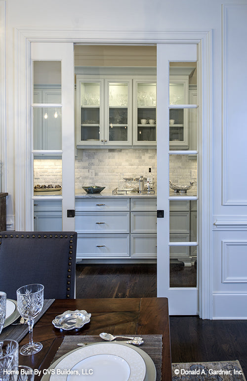 Glass pocket doors in the dining room leading to the butler's pantry. The Carrera plan 1178.