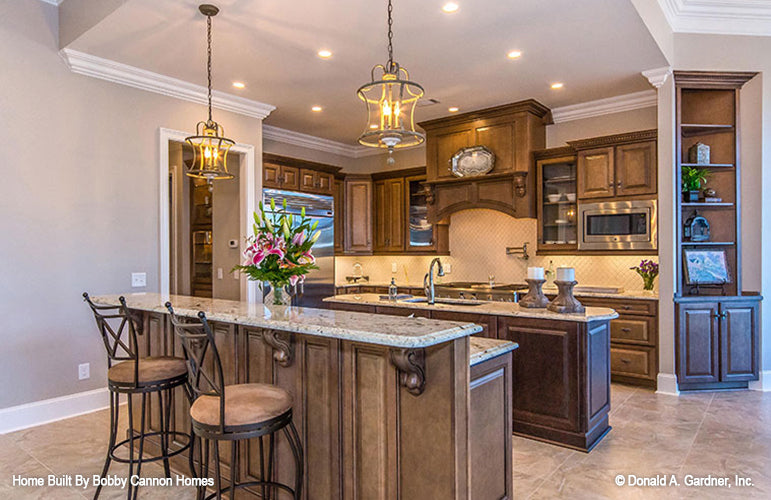 Second island with bar and seating in the kitchen. The Cedar Court plan 5004.