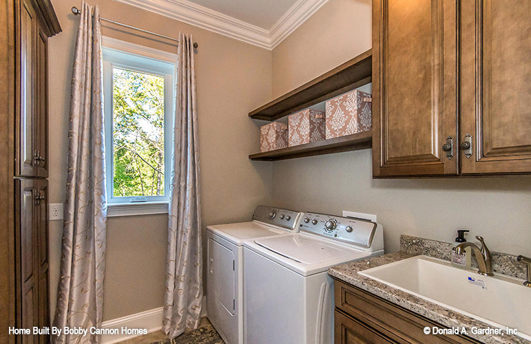 Sink and washer and dryer in the utility room. The Cedar Court plan 5004.