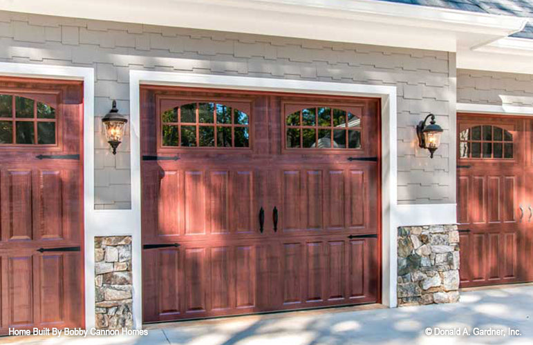 Brown wood effect garage doors. The Cedar Court plan 5004.