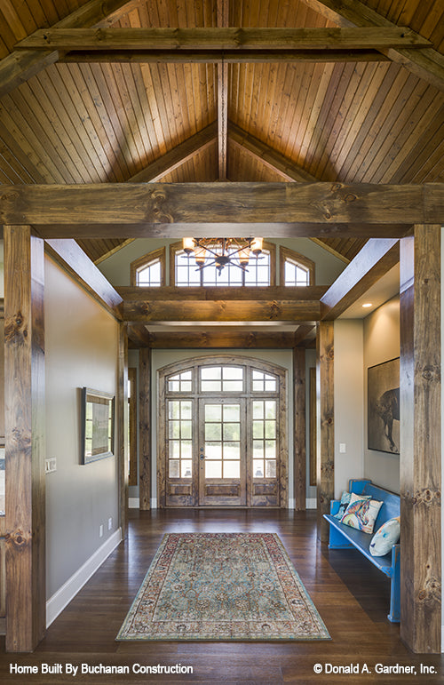 Spacious foyer with wood paneling and beams on the vaulted ceiling. The Cedar Creek plan 959 