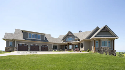 Front view photograph submitted by customer with three car garage. The Cedar Creek plan 959 