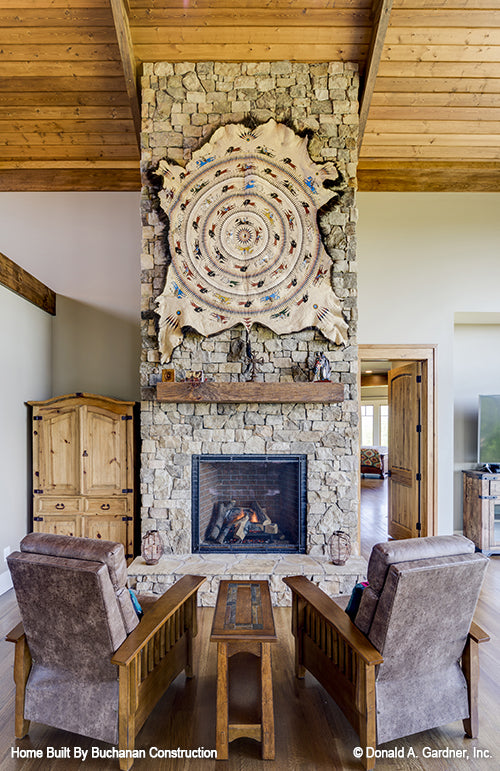 Great room sitting area in front of the stone fireplace. The Cedar Creek plan 959 