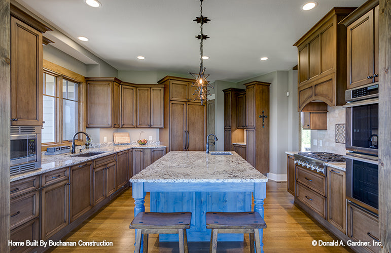 Lots of cabinet space in the kitchen along with island seating. The Cedar Creek plan 959 