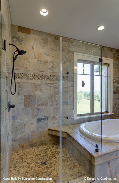 Walkin-shower with see-through glass beside the tub. The Cedar Creek plan 959 