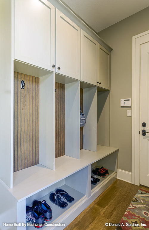 Storage space and bench in the mud room. The Cedar Creek plan 959 