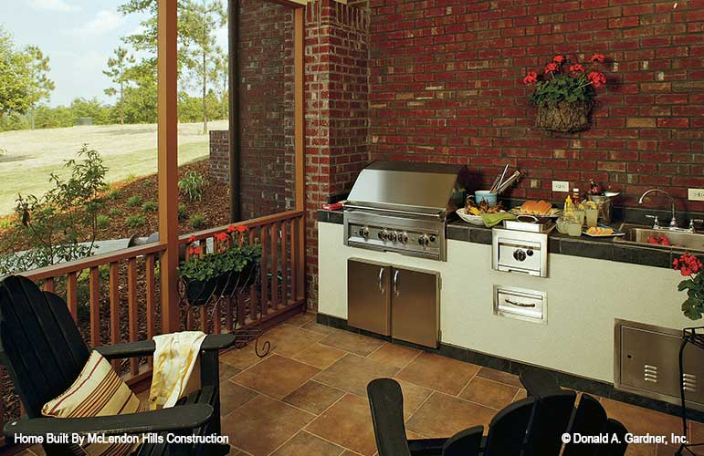 This is the outdoor kitchen on the screened porch for walkout basement house plan 1125 The Cedar Ridge