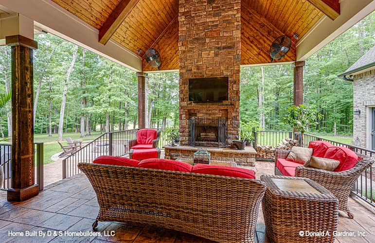 Rear porch picture with fireplace for one story house plan 1323 The Celeste