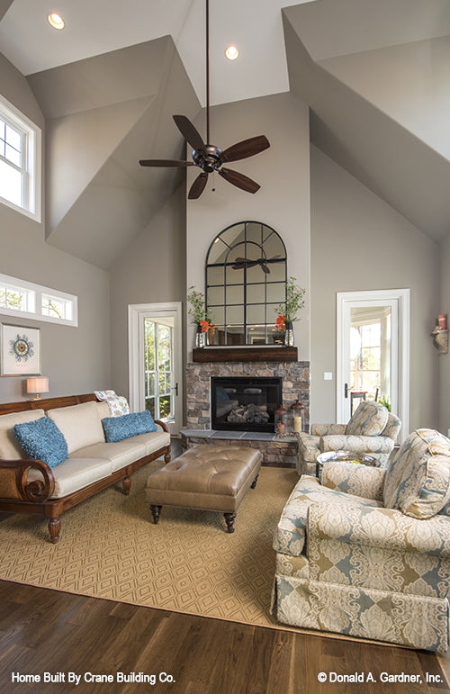 Family room picture with compound vaulted ceiling of luxury house plan 1253 The Chamberlaine