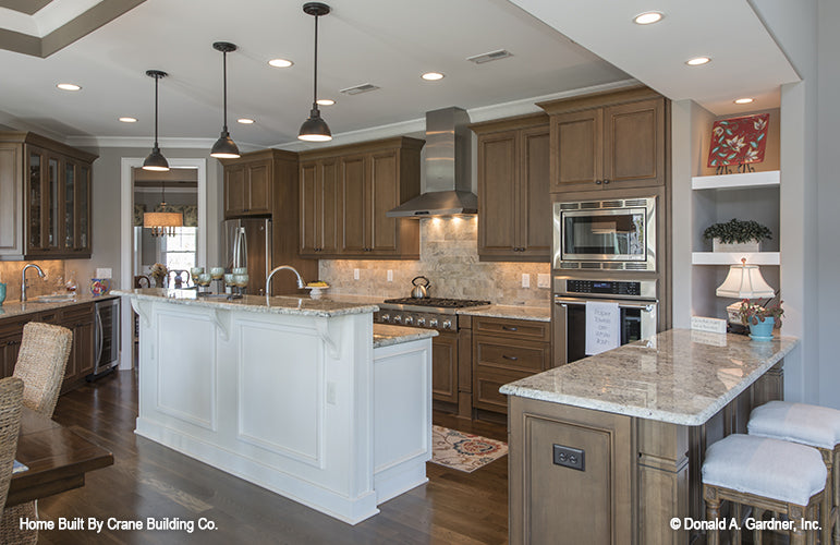 Kitchen island and bar area of luxury house plan 1253 The Chamberlaine