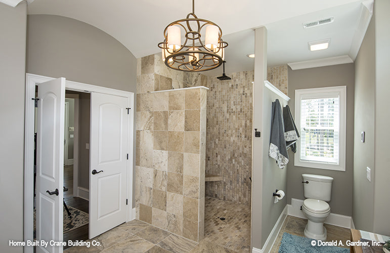 Master bathroom picture with shower and toilet room of luxury house plan 1253 The Chamberlaine