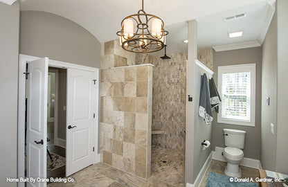 Master bathroom picture with shower and toilet room of luxury house plan 1253 The Chamberlaine