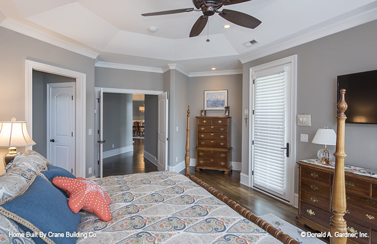 Master bedroom with decorative ceiling of luxury house plan 1253 The Chamberlaine 