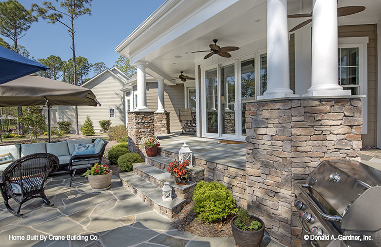 Rear porch and patio area  of luxury house plan 1253 The Chamberlaine