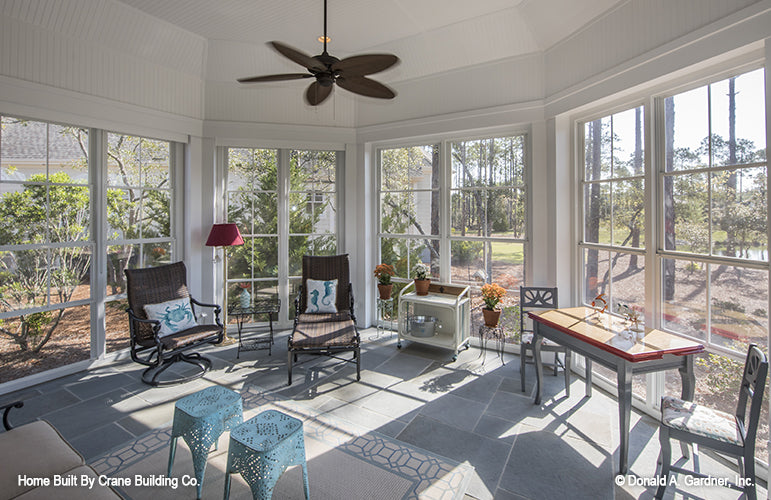 Screened porch with sitting area of luxury house plan 1253 The Chamberlaine