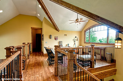 Sitting area with arched window in the loft. The Chanticleer plan 810.