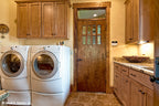 Wood cabinets in the utility room. The Chanticleer plan 810.