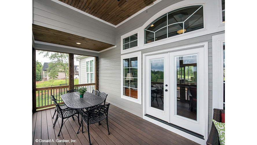 Glass patio doors in the screened in porch. The Charlevoix plan 1068.