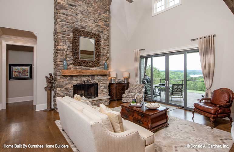 Great room stone fire place and double doors leading to the porch. The Chatsworth plan 1301.