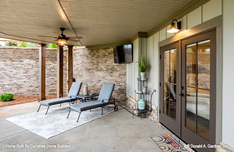 Covered patio with tv outside the French doors from the master bedroom. The Chatsworth plan 1301. 