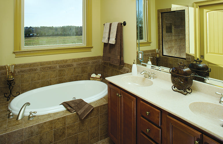 Double sink vanity next to the soaking tub in the master bathroom. The Clearly plan 948.