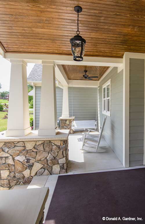 Perfect porch for relaxing, wood panels on the porch ceiling along with an outdoor ceiling fan. The Cline plan 1419