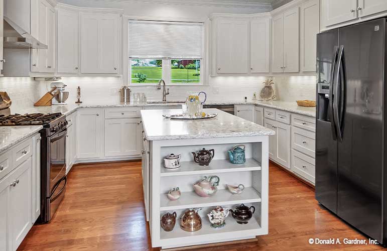 Full view of the kitchen, appliances off to each side with island in the middle. The Cline plan 1419