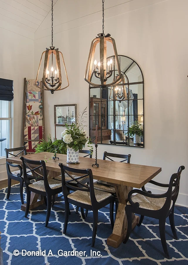 An open dining room gives space for both formal and casual dining for modern farmhouse house plan 1335 The Coleraine