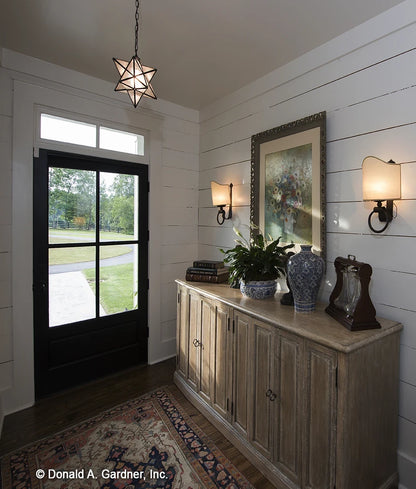 The foyer makes the first impression for visitors to modern farmhouse house plan 1335 The Coleraine