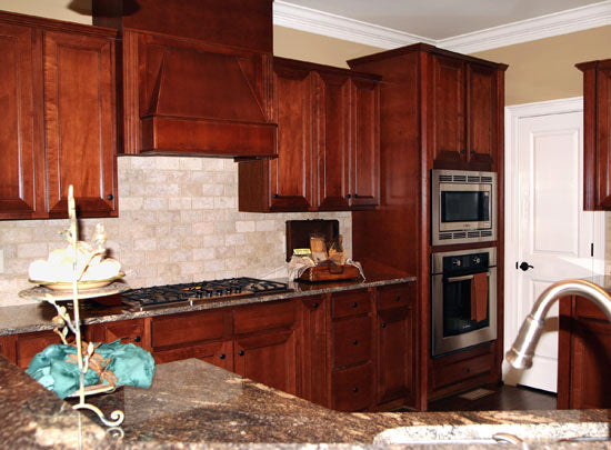 Stained wood cabinets in the kitchen. The Collier plan 1216.