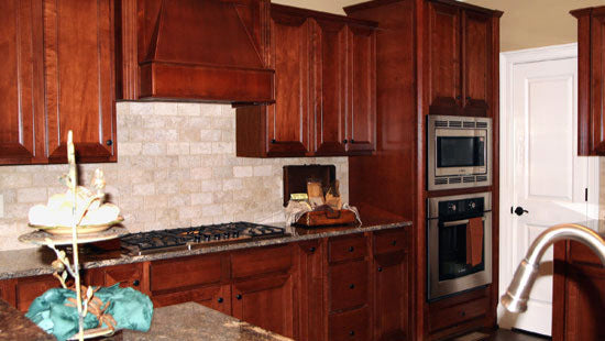 Stained wood cabinets in the kitchen. The Collier plan 1216.