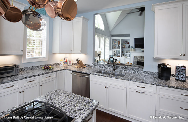 This is a picture of the kitchen with great room view of cottage house plan 923 The Colthorpe