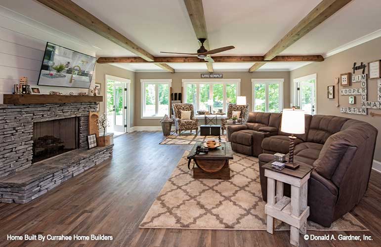 This is a photograph of the entertainment room and fireplace of luxury house plan 732 The Crowne Canyon as built by a customer