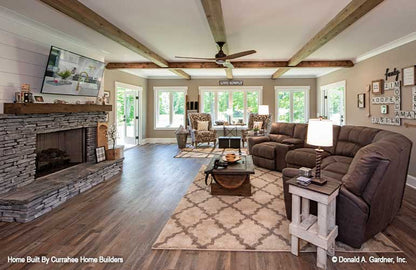 This is a photograph of the entertainment room and fireplace of luxury house plan 732 The Crowne Canyon as built by a customer