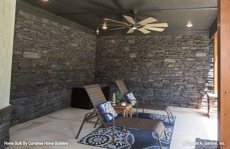 This is a photograph of the patio lounge area of luxury house plan 732 The Crowne Canyon as built by a customer