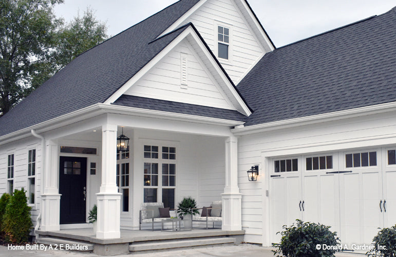 This is a picture of the front porch and garage of house plan 1025 The Currier as built by a customer 