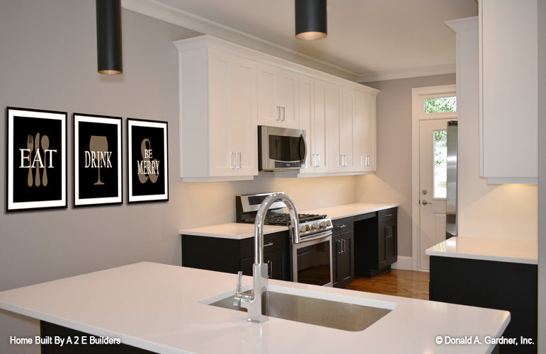 This is a picture of the kitchen, island and counter space of house plan 1025 The Currier