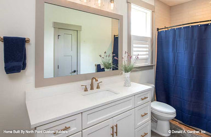 Elegant full bathroom with window above toilet area. Dawson plan 1502