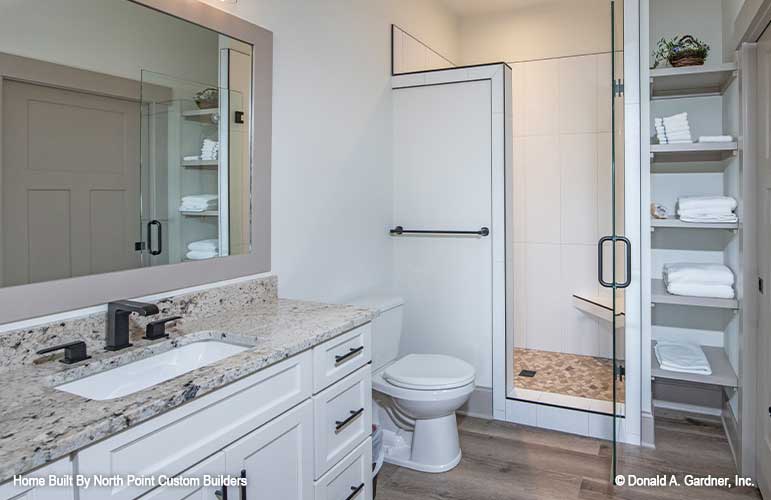 Gorgeous bathroom with walk-in shower and open linen shelving. Dawson plan 1502