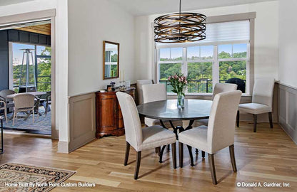 Dining room with a view outside from the triple windows. Dawson plan 1502