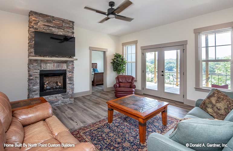 Entertainment room with stone fireplace and French doors to the deck. Dawson plan 1502