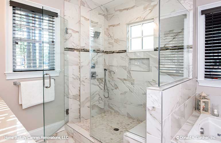 A large shower highlights the master bathroom in open concept house plan 1371 The Drake