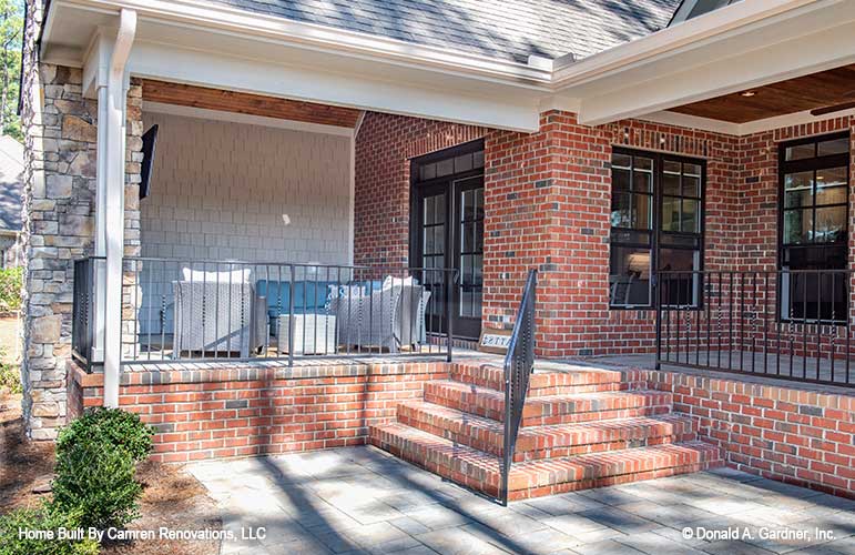 Outdoor living begins with this patio in one story house plan 1371 The Drake