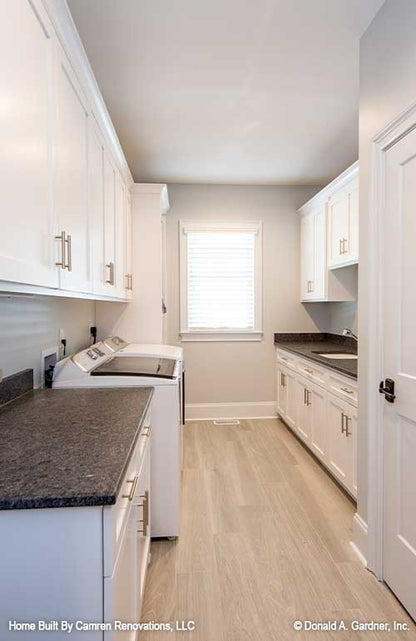 Plenty of storage and counter space in the utility room in open concept house plan 1371 The Drake