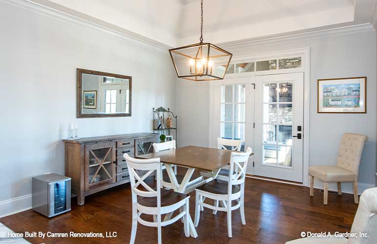 An open dining room gives space for both formal and casual dining for craftsman house plan 1371 The Drake