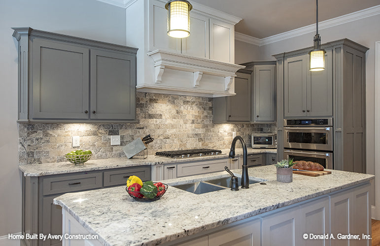 Gray cabinets and tile backsplash in the kitchen. The Drayton Hall plan 1238.