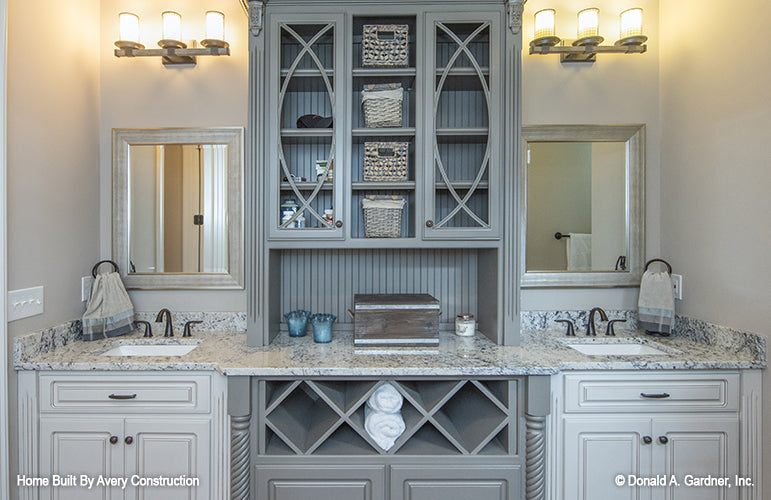 Double sink vanity with cabinets in the center in the master bathroom. The Drayton Hall plan 1238.