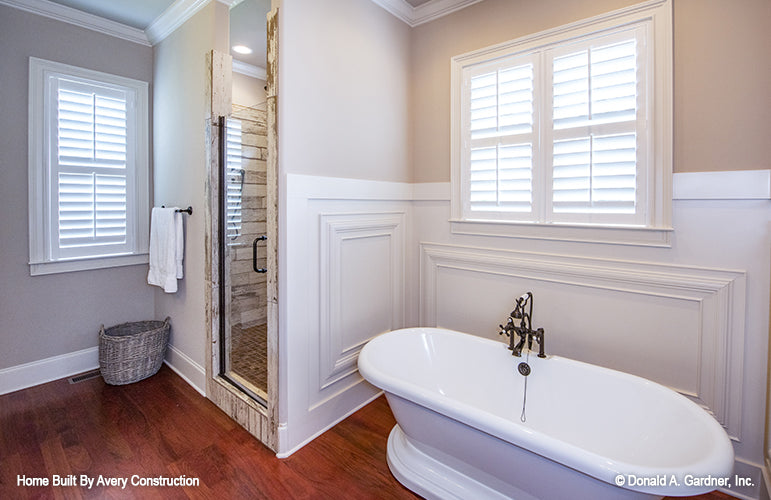 Soaking tub beside a walk-in shower in the master bathroom. The Drayton Hall plan 1238.