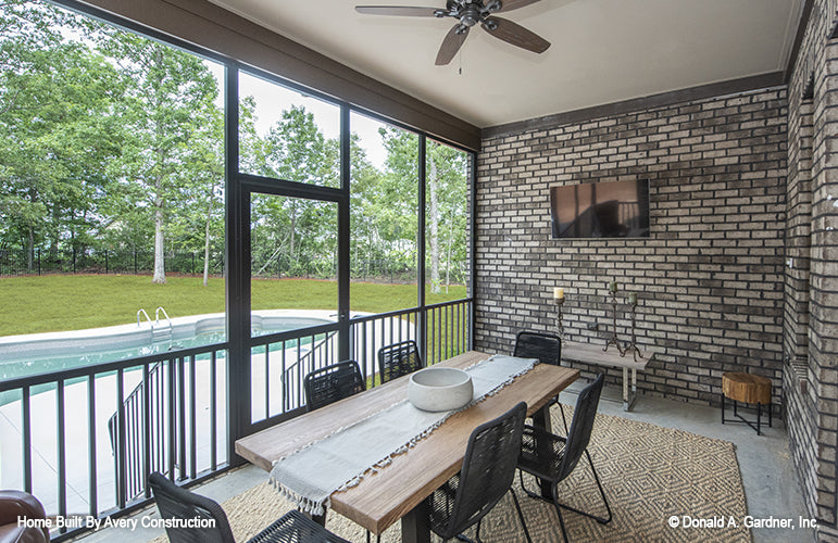 Outdoor TV and dining table on the screened in porch. The Drayton Hall plan 1238.